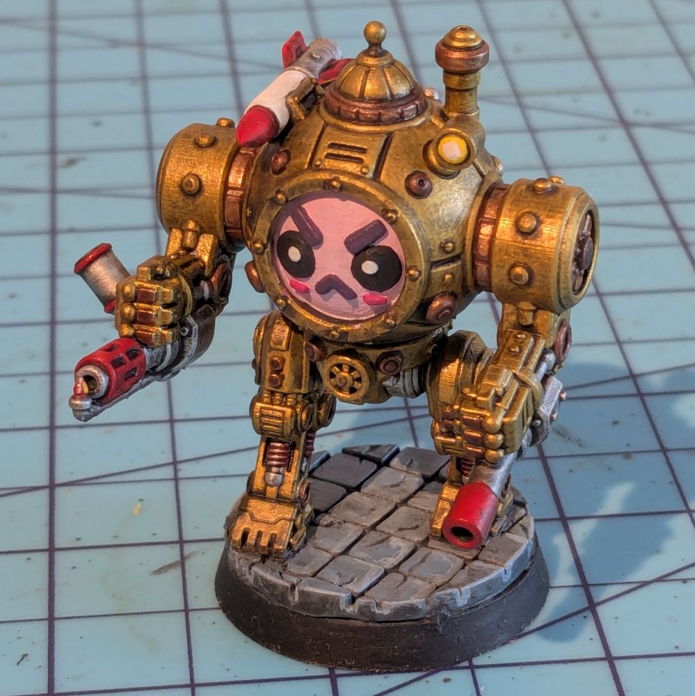 A steampunk mech miniature with an angry face in a cute uwu style. The mech is walking on a cobblestone street