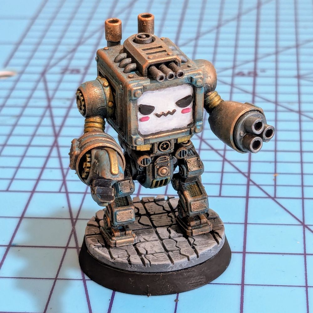 A steampunk mech miniature painted to look like oxidized copper. It has a sneaky look and boxy head