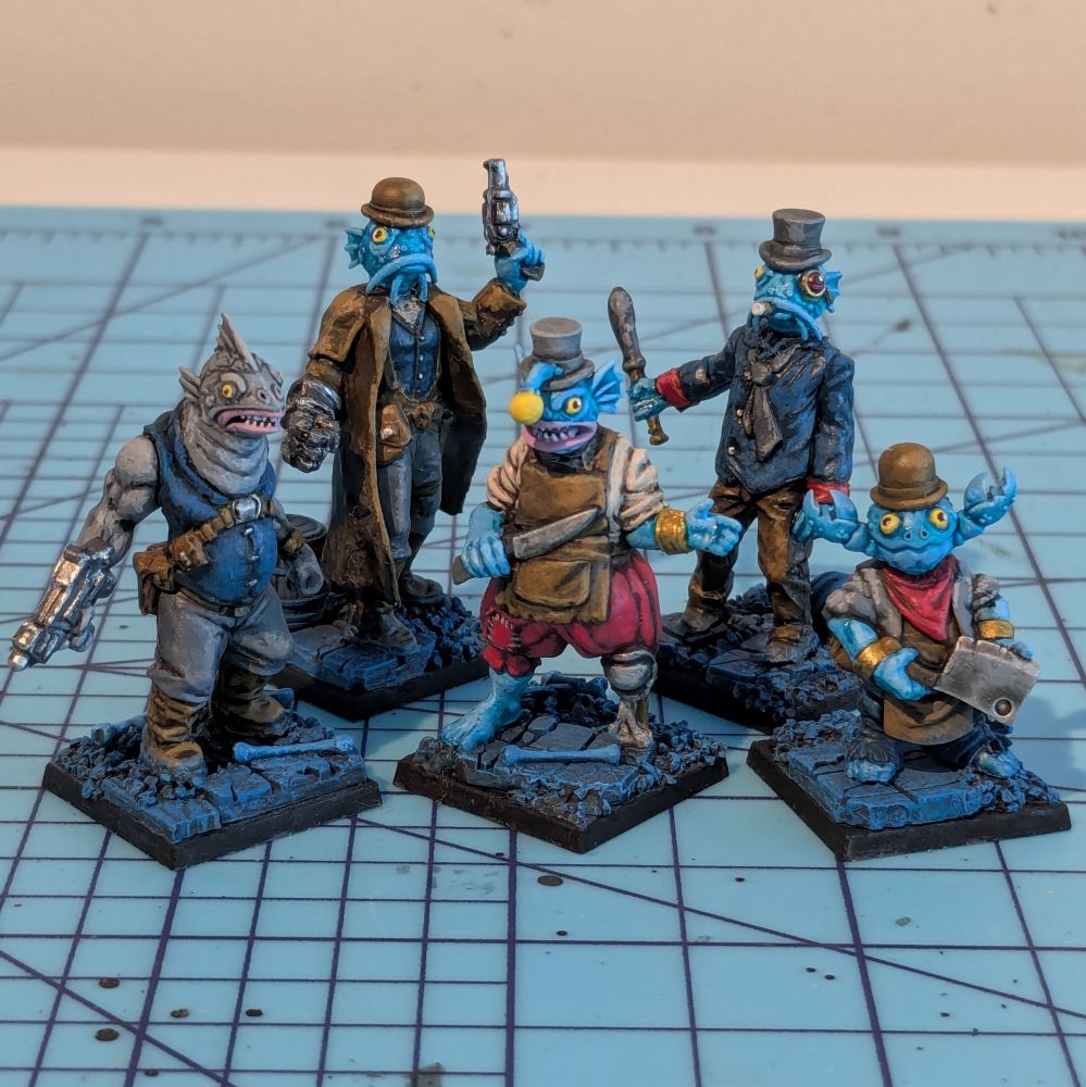 A group of five pirate fish people miniatures. They have human bodies and fish-like heads 