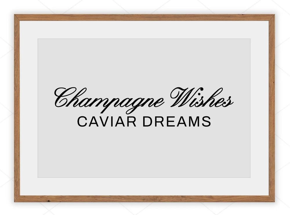 Sign that says champagne wishes caviar dreams, black text white background, champagne wishes in script
