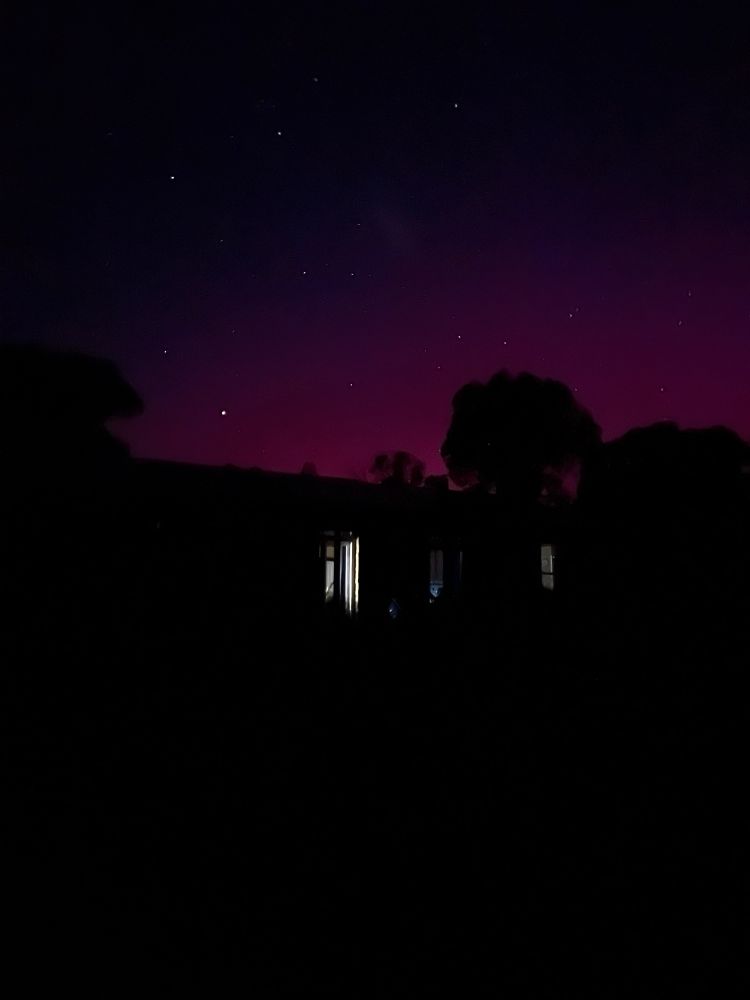 Pink Aurora over house silhouette