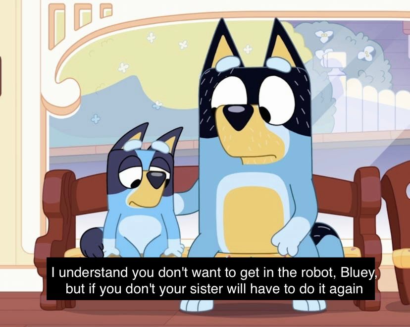 Bandit Heeler sitting next to Bluey. He looks sympathetic and she looks sad. The caption on the image says "I understand you don't want to get in the robot, Bluey, but if you don't your sister will have to do it again"