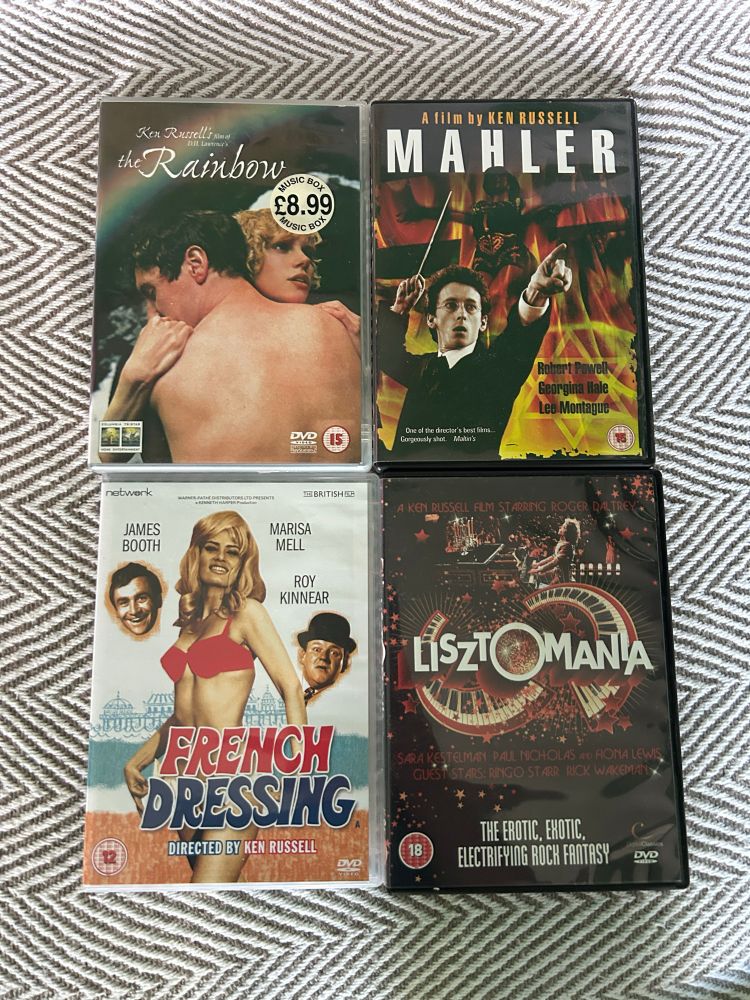 4 DVDs of films by Ken Russell on my sofa. They are The Rainbow, Mahler, French Dressing and Lisztomania.