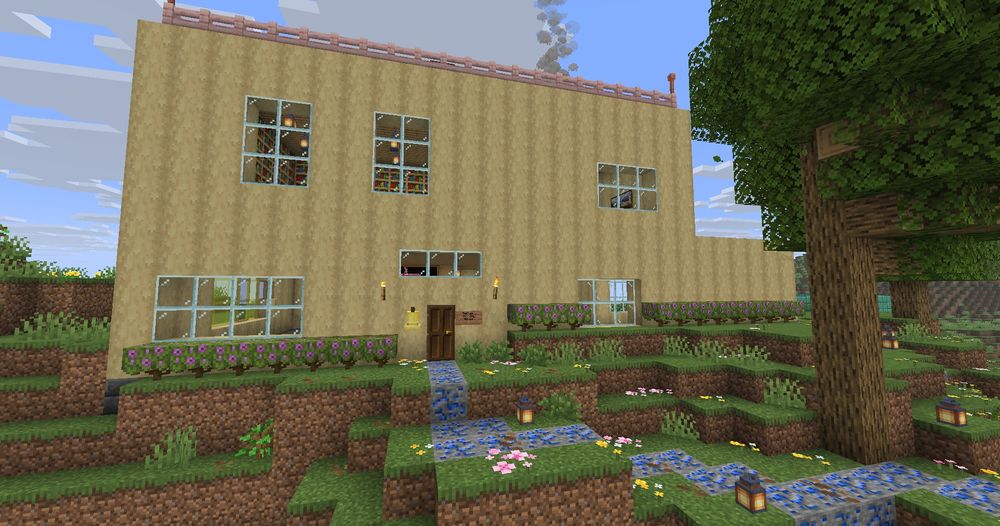 A screenshot of a tan-colored 2 story house created in Minecraft