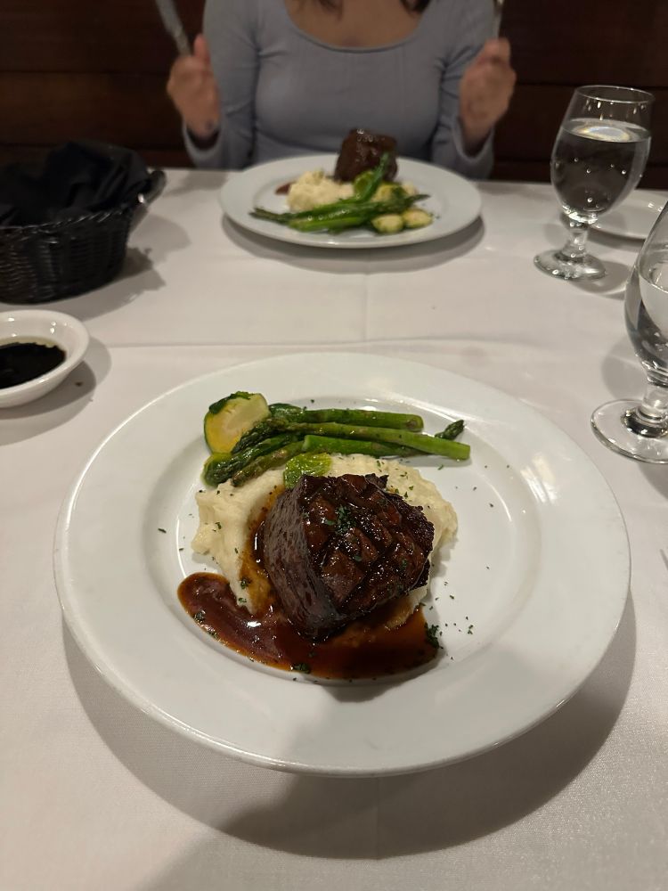 Filet mignon with mashed potatoes, asparagus, brussel sprouts, and a demi glacé sauce