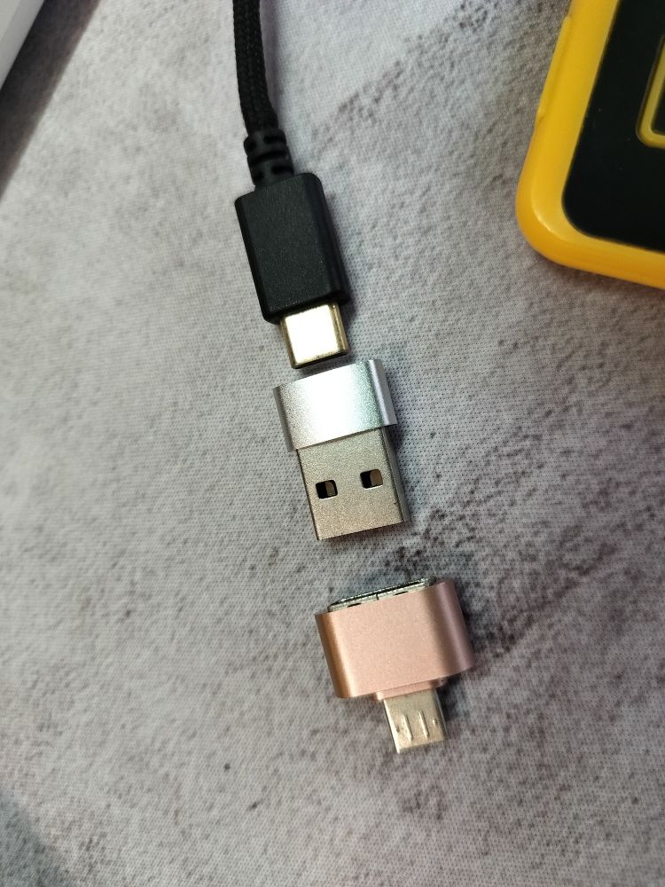 USB c cable connecting to a USB c to USB a adapter connecting to a USB a to USB micro b adapter