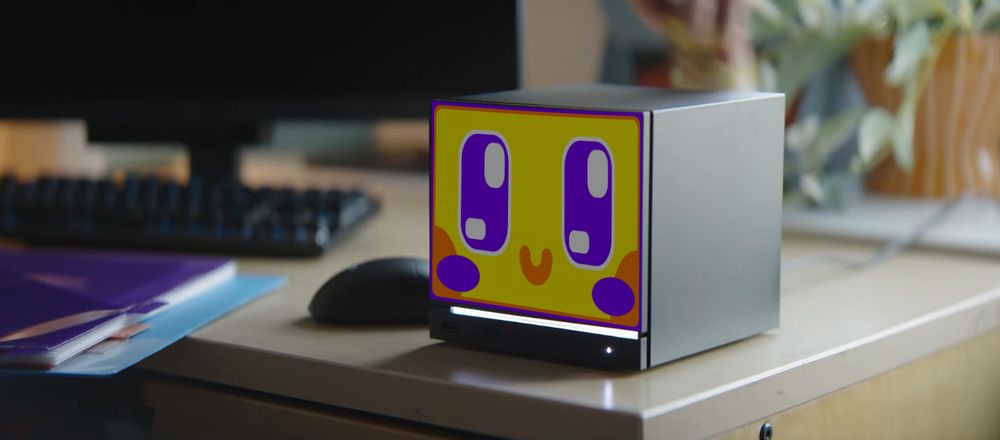 image of a Valve Steam Machine on a desk with the front plate edited to look like a VTuber's TV shaped head