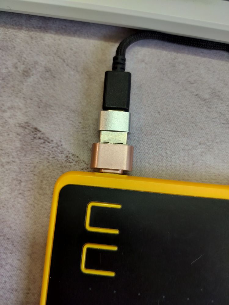 USB c cable with an adapter connected to an adapter to a drawing tablet