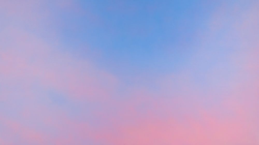 A serene sky with soft pink and blue hues blending together, creating a calming gradient effect.