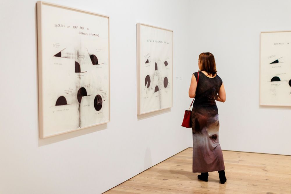 A person viewing abstract artworks at the Whitney Museum.