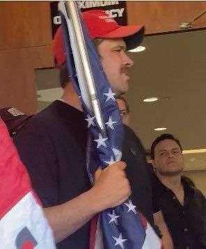 Nick Taurus in the red hat, with Ryan Sanchez in a black shirt behind him 