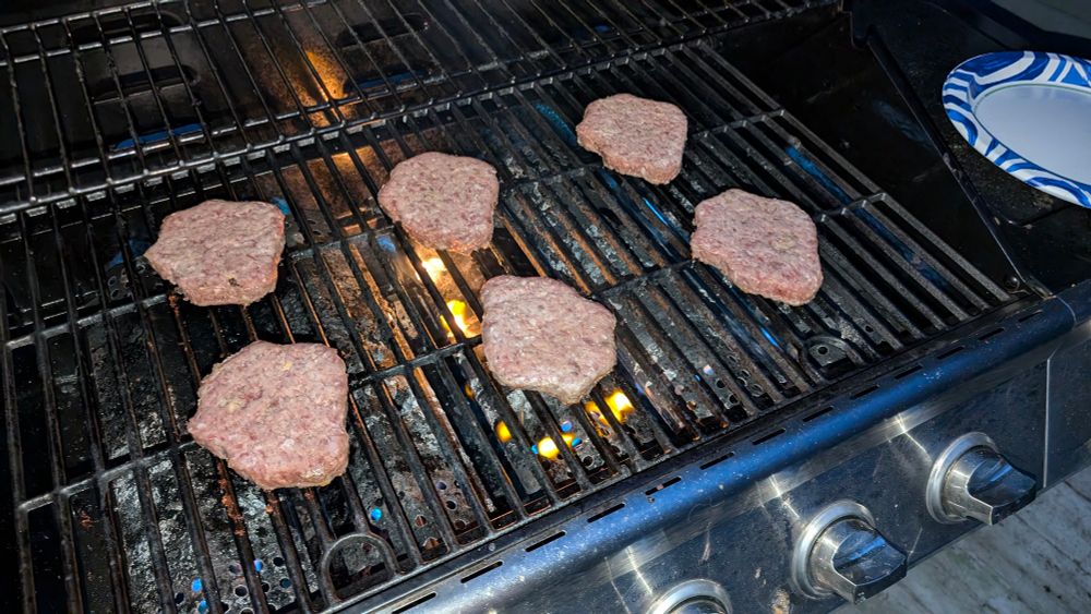 Burgers cooking on a grill