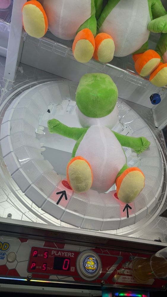 Yoshi plush trapped in an Arcade Machine