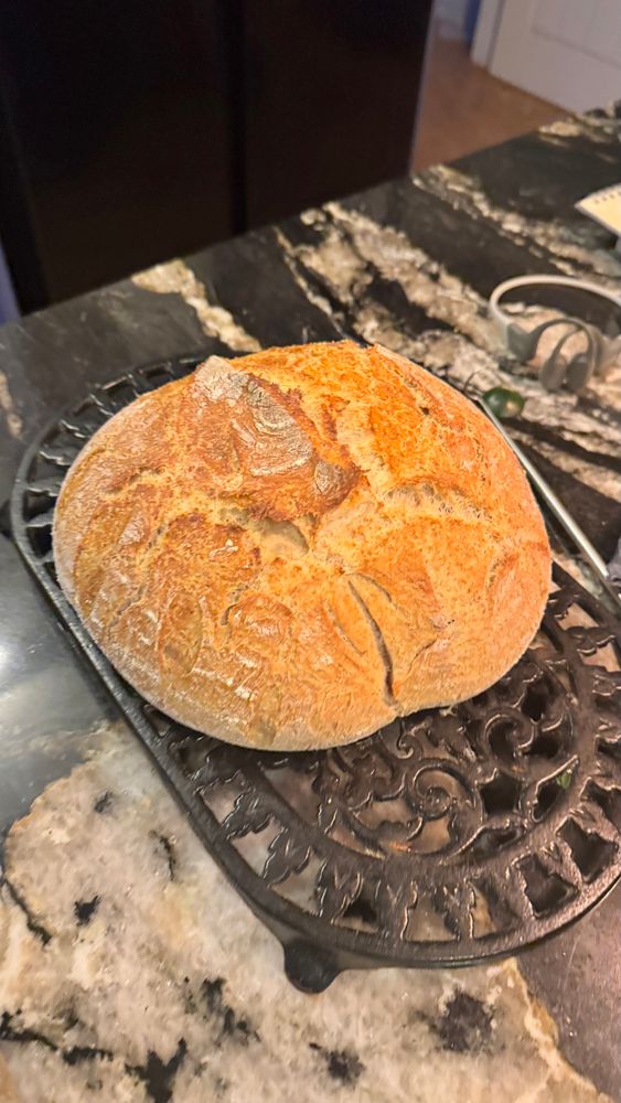 A loaf of fresh sourdough bread, with a nice golden crust. 