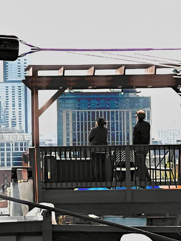 Two people contemplate the Baltimore skyline