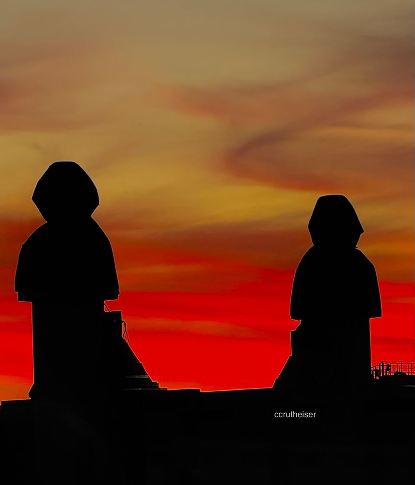 Hunan shapes silhouetted against the sunset gloaming
