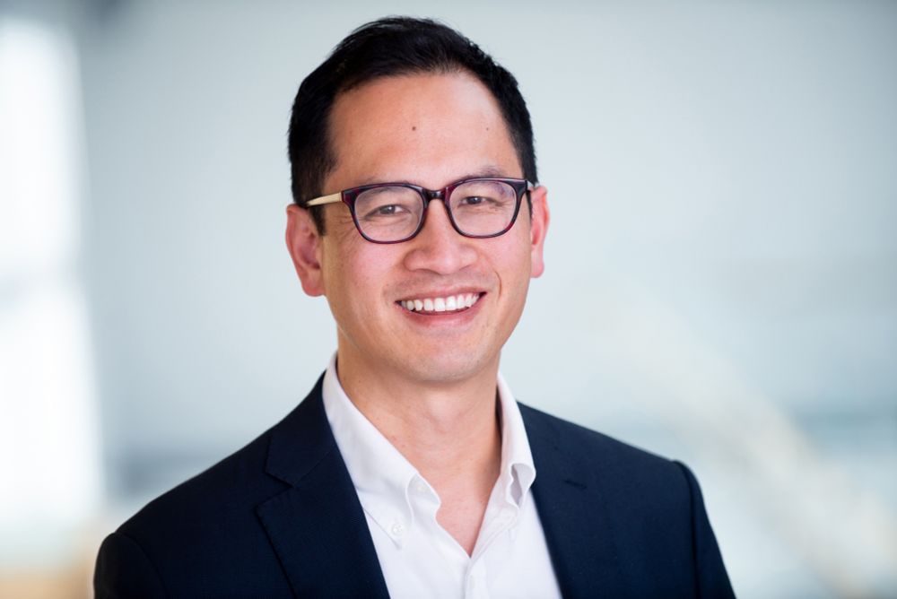 Dr. Edward Chang poses in a blazer and white button-down shirt.