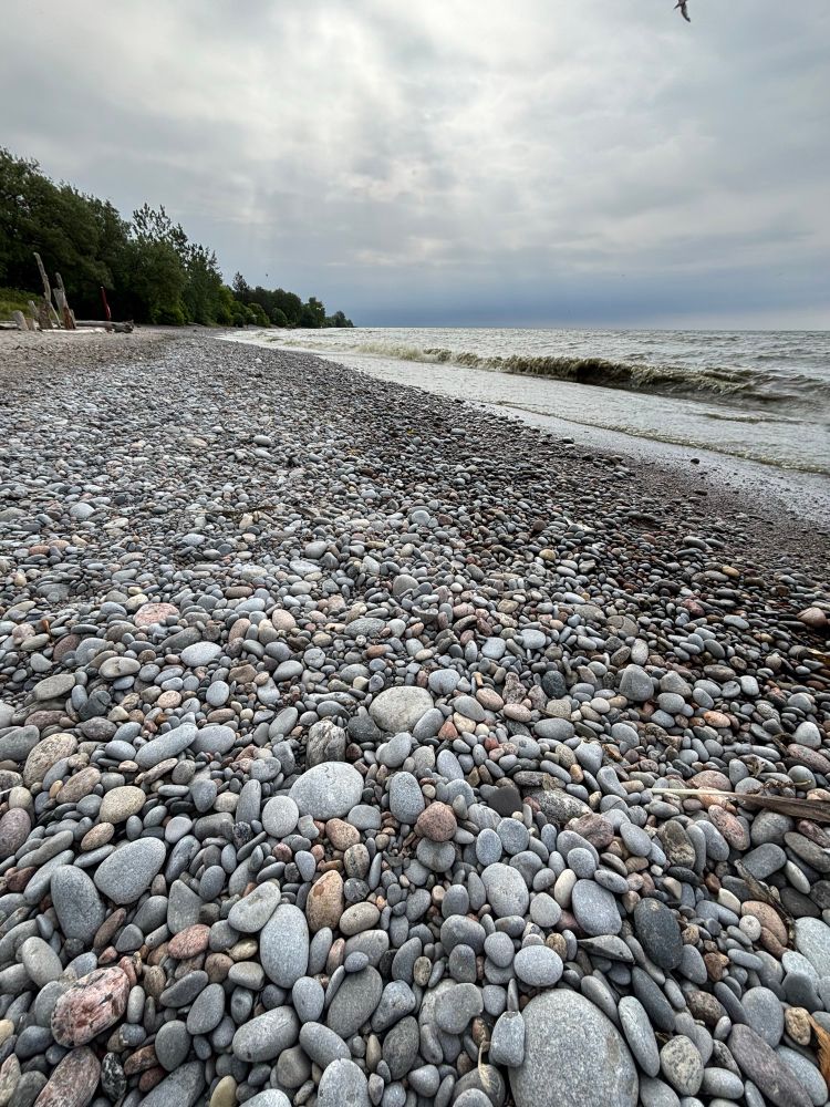 Lots of rocks in the foreground and Lake Ontario in the background at Paradise Beach in Ajax, Ontario. 
