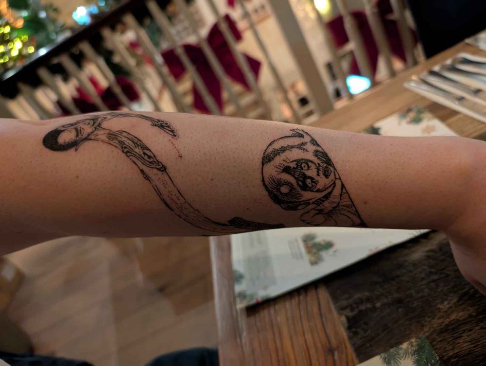 Harry Clarke's Faust illustrations as tattoos on an arm.