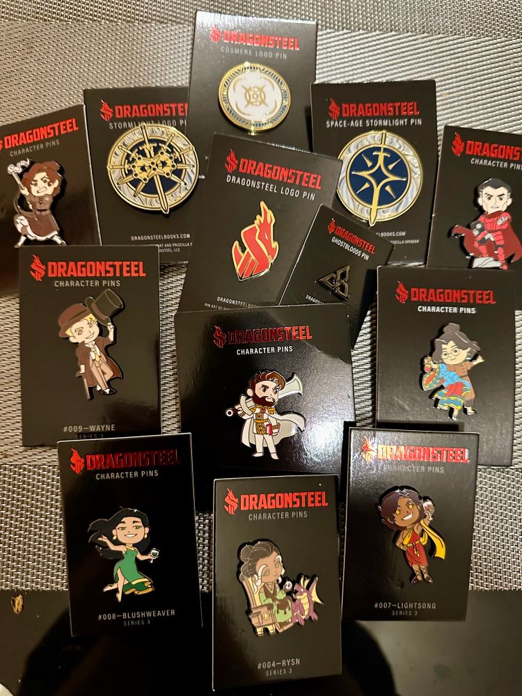 Picture of my new Dragonsteel pin badge collection additions.