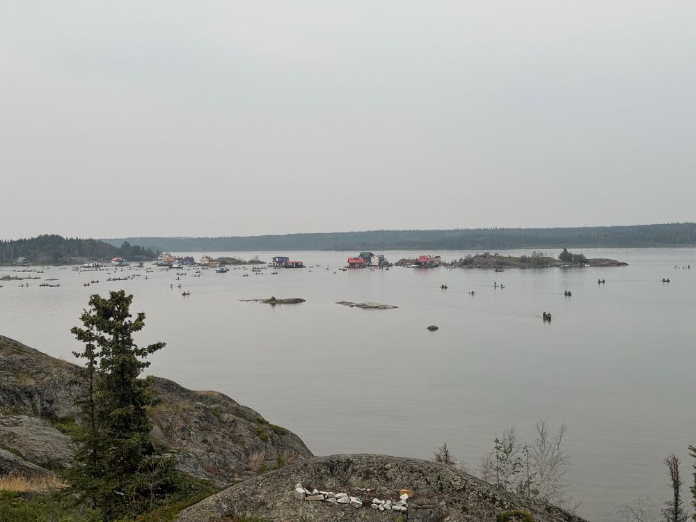 People paddle back to shore after a floating concert on Yellowknife Bay