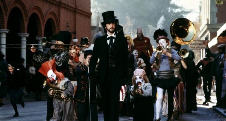 Screen shot of Jonathan Pryce as Mr. Darrk as he leads the parade through town in the film adaptation of Ray Bradbury’s Something Wicked This Way Comes. 