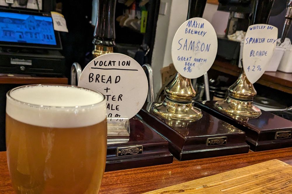 Nice pint of Bread + Butter Pale Ale in front of three pumps with hand scrawled descriptions in place of brewery supplied clips - Marine, Saltburn by Sea