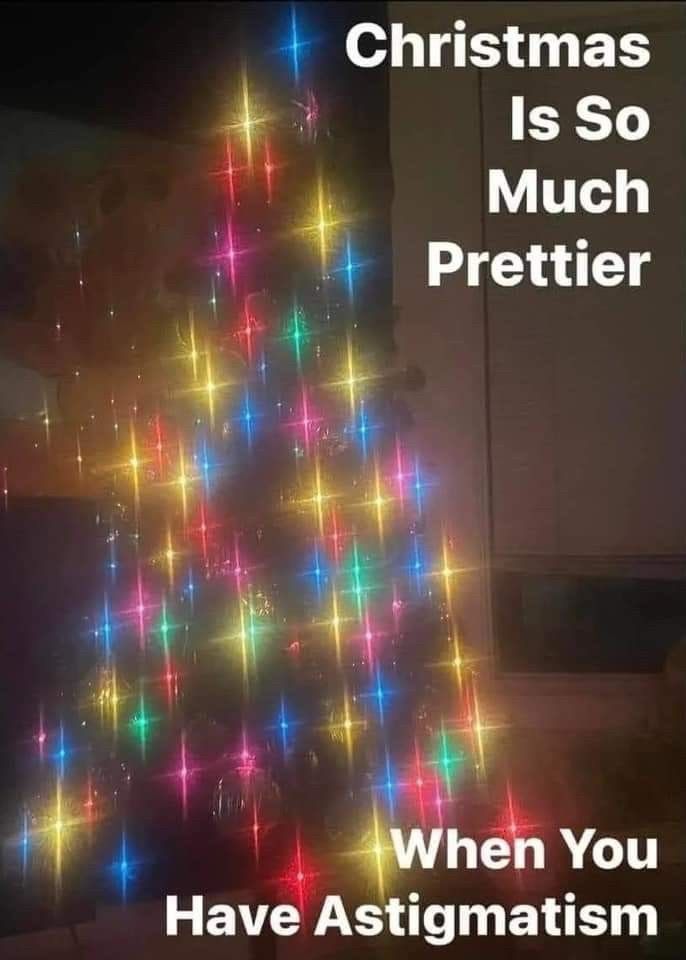 A photo of a Christmas tree with blurry, twinkling lights that approximates how someone with astigmatism sees the tree without visual aids. It’s objectively more magical than an in-focus tree.