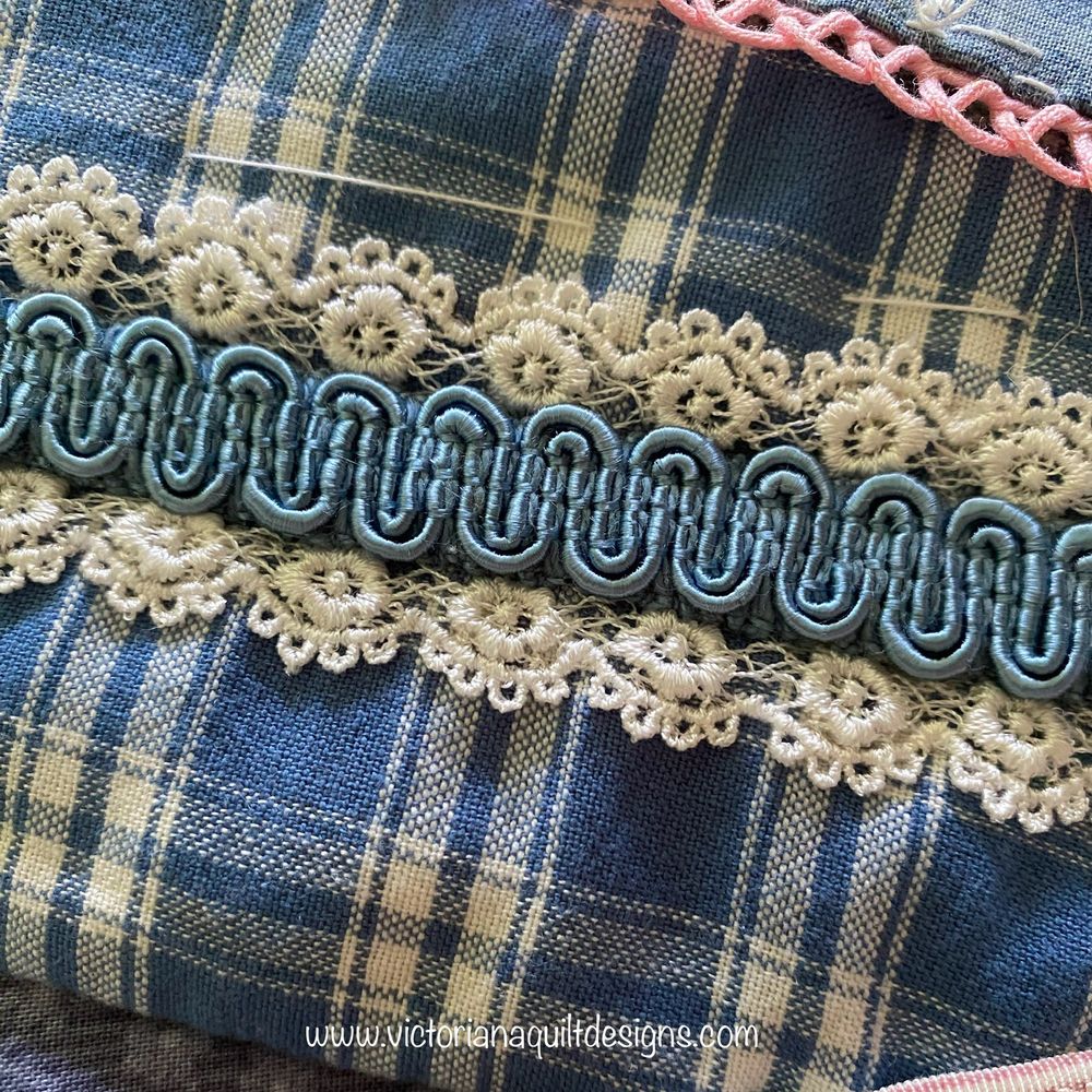 Blue & cream plaid fabric piece, decorated with blue trim in cream lace. 