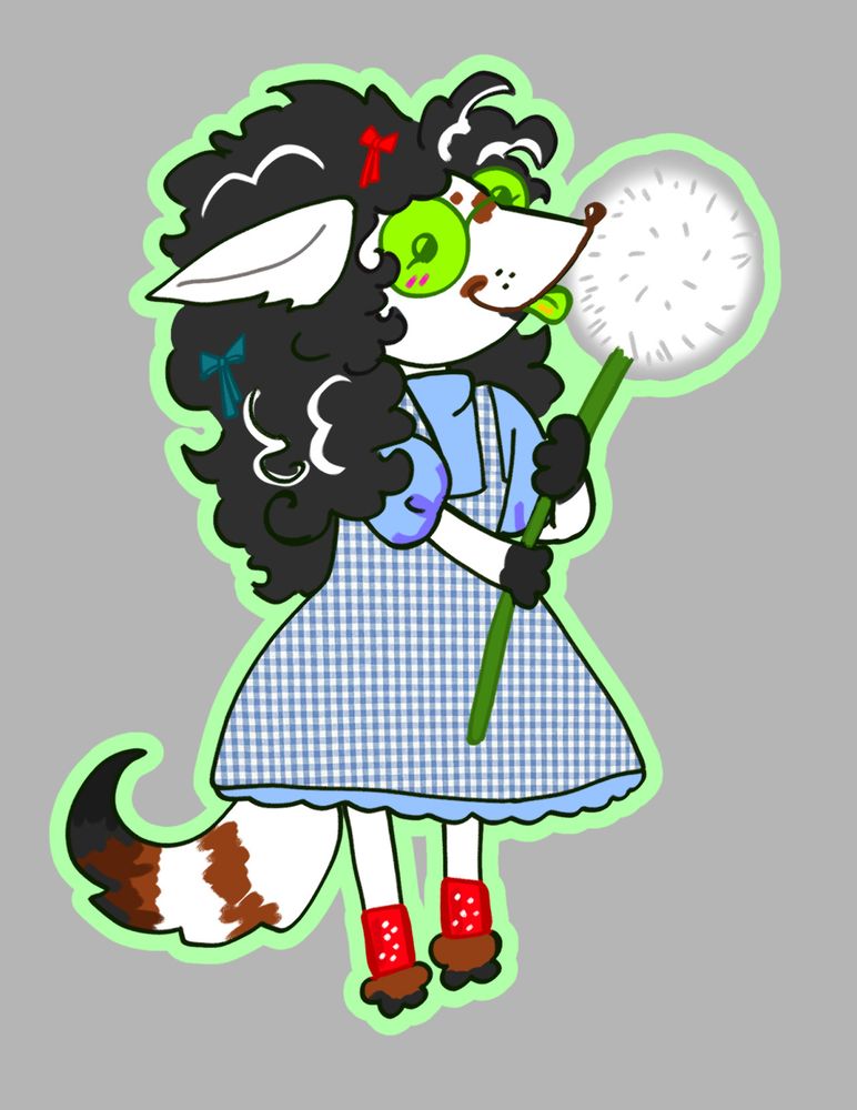 Jade Harley is a small dog with spark-shaped ears and brown, white, and black fur. She has black hair with white streaks, green round glasses, and a green tongue. She's looking at the camera with her tongue out, smiling, while holding a dandelion that's as big as she is. She's wearing a blue dress with checkered blue overalls, one cherry red bow and one teal bow, and cherry red sparkly leg bands.