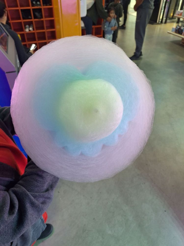 Pink, blue and yellow cotton candy in the shape of a heart