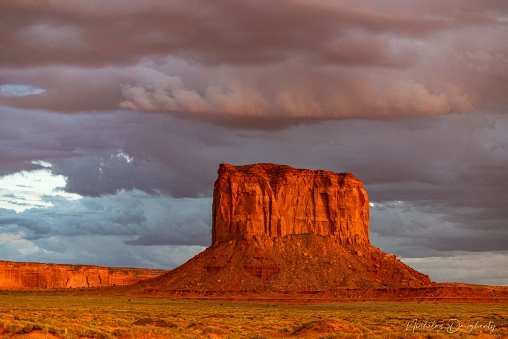 A butte in Monument Valley with storm clouds