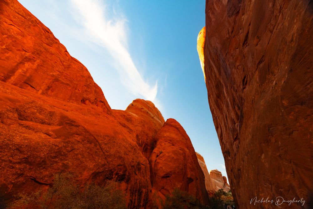 Large red rock walls form a narrow corridor