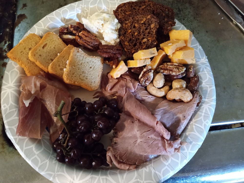Charcuterie plate, with meat cheese, nuts, crackers, and fruit 