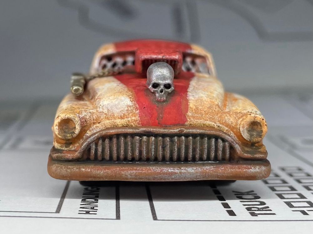 A hot wheels car that had been converted into a grimy battle car for the tabletop game Gaslands 