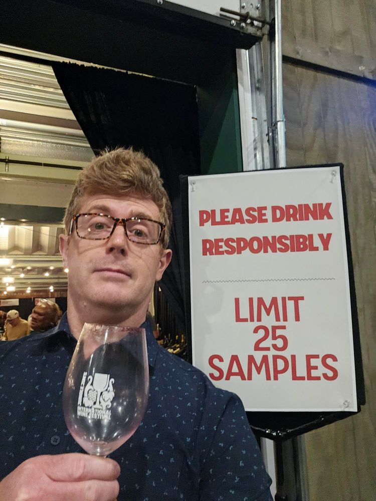 Guy next to sign everyone ignores that says limit 25 samples of wine