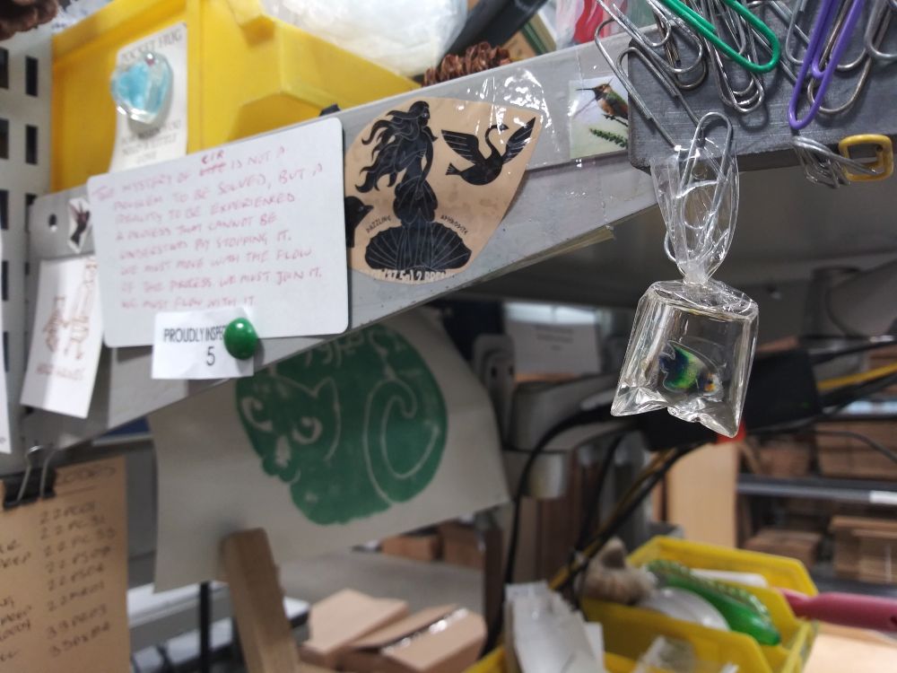 Detail of my workbench featuring a miniature fish in a bag