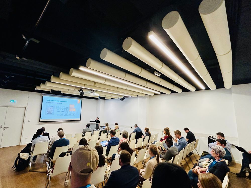 Conference room with audience members listening during a presentation by the RescueME project