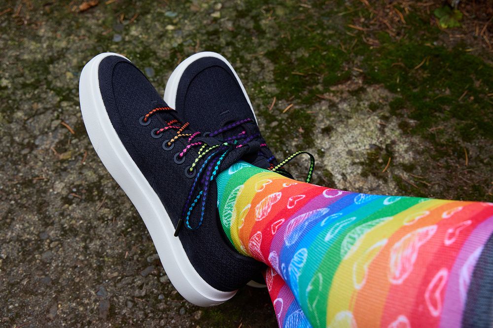 Black handwoven shoelaces with rainbow hearts on black shoes with rainbow heart themed socks.