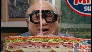 Danny DeVito in goggles watching a Jersey Mike's sub get absolutely doused in what is supposed to be oil and vinegar but is maybe piss