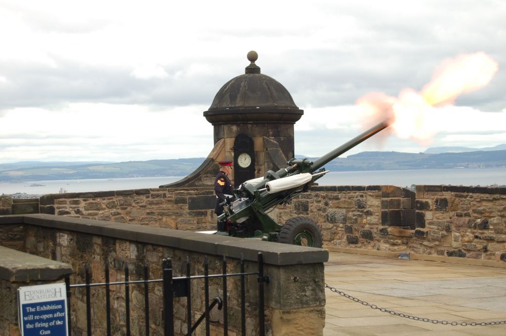 One O’Clock Gun (cannon) firing from Edinburgh Castle to mark the time 