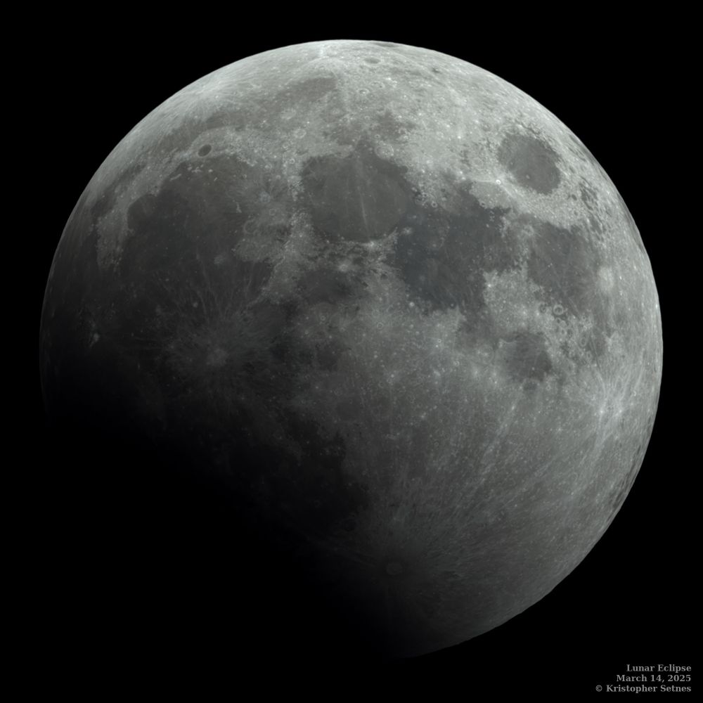The moon partially covered by Earth's shadow.