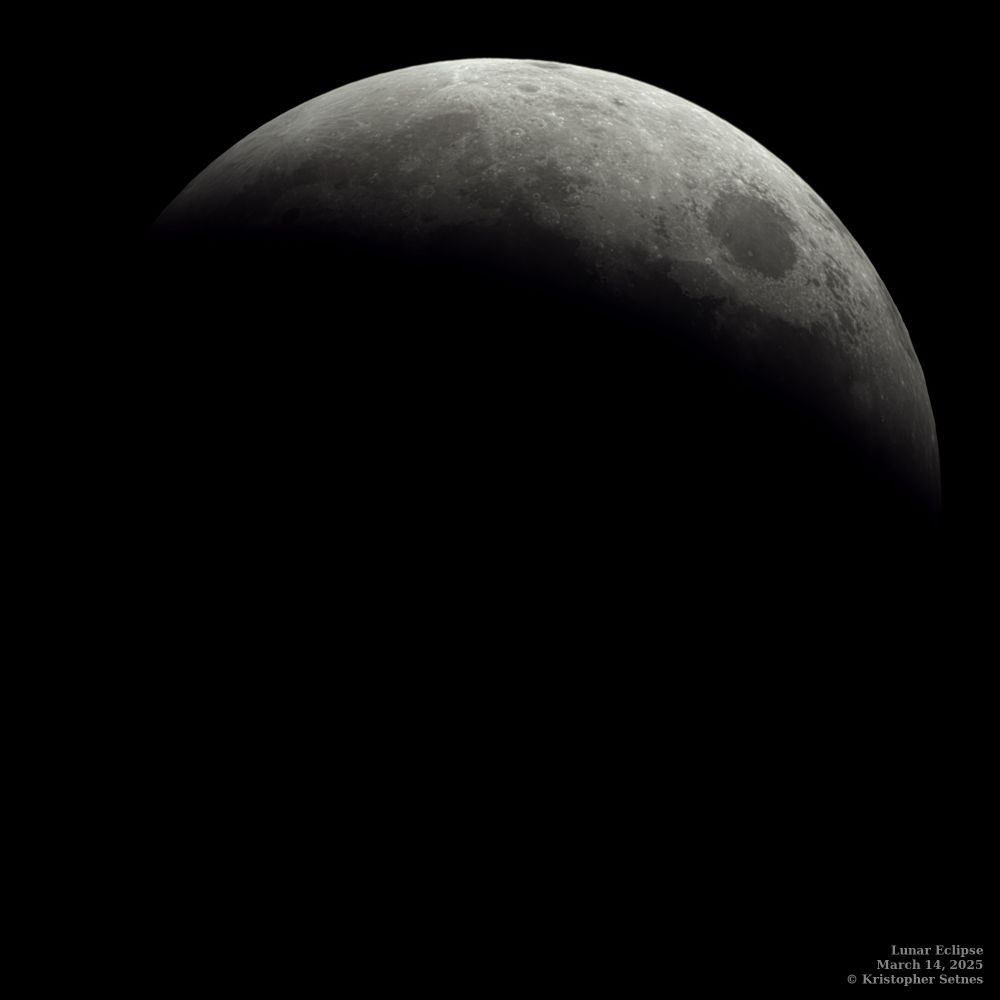 The moon partially covered by Earth's shadow.