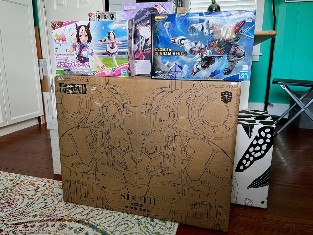 Model kit loot! Bandai's Figure-rise Standard Special Week, Kotobukiya's Sousai Shojo Teien Arranged Wig Hime (Princess) Cut Ponytail, Bandai's MGSD Gundam Aerial, and beneath them all, MS General's Sin Series Sloth, in its own huge outer shipping box, UPS labels removed