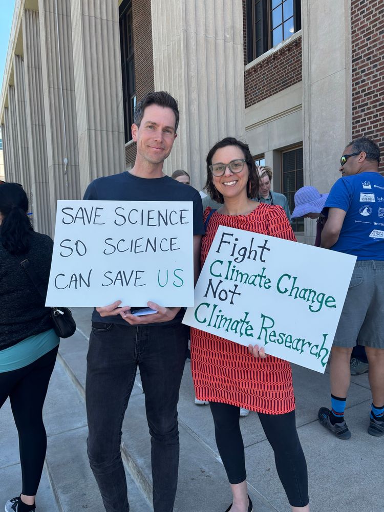 Holding protest signs for science and research. 