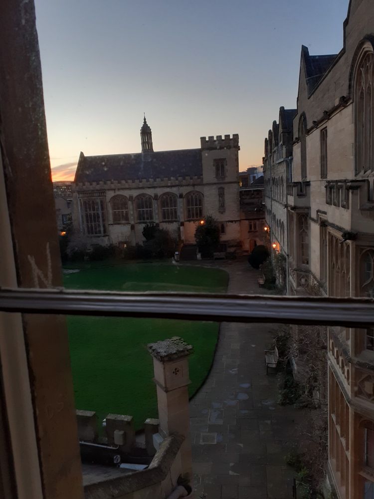 View of Pembroke College Oxford showing the Chapel and green grass of a quadrangle.