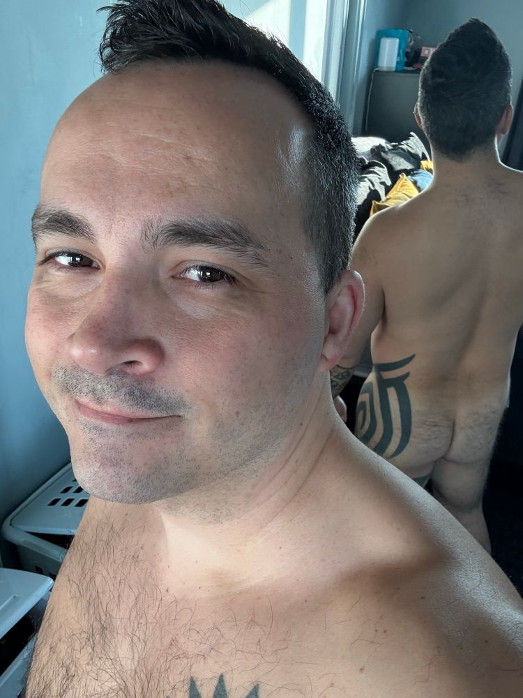 Mirror selfie showing my clean shaven face in support of Movember and raising funds to support men’s health and fight cancer. My bare ass is reflected over my shoulder 