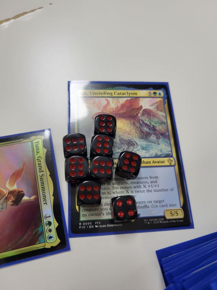 A card from the same deck, played about a week later, which has so many counters on it that its player ran out of paper counters, so dice had to be used as a replacement. It has a total of 46(?) counters on it, making it a 51(?)/51(?) Instead of a 5/5