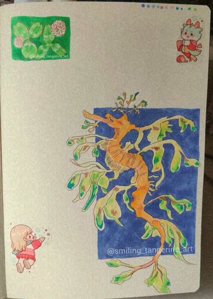 The full page featuring both the leafy seadragon and clover drawings and some stickers as decoration 