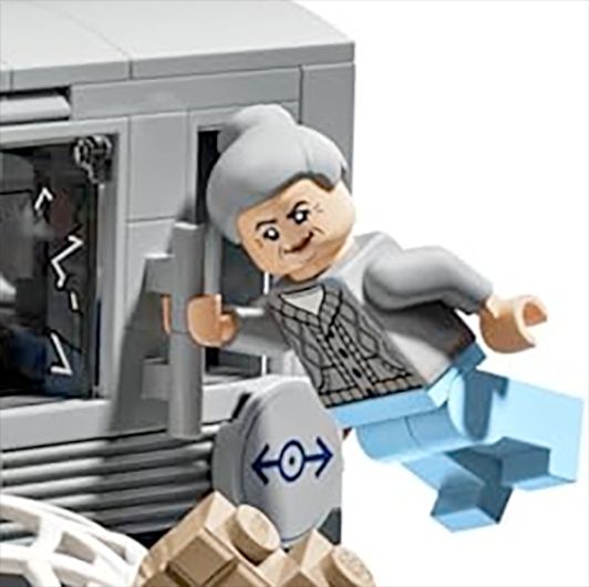 A close-up of the Aunt May figure who is hanging on to the subway train with one hand and looks pretty smug about it.